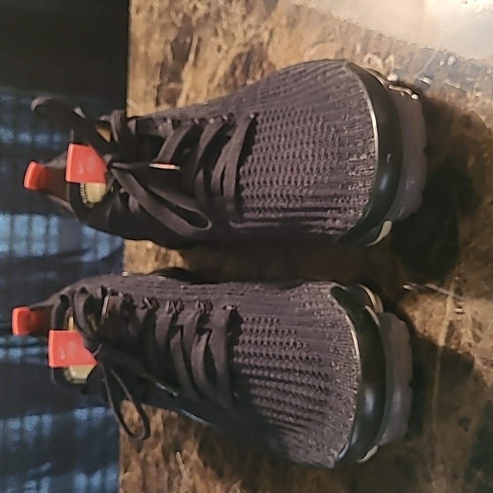 Men's black mesh, with orange logo, vapormax nike sneakers.